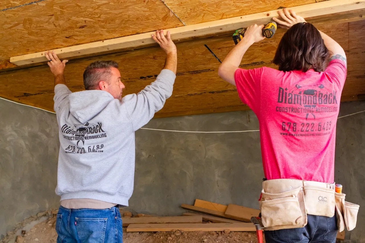 Two men working on ceiling installation